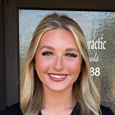 Professional headshot of a person with shoulder-length blonde hair