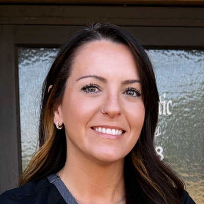 Professional headshot of a person with long dark hair