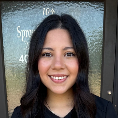 Professional headshot of a person with long dark hair